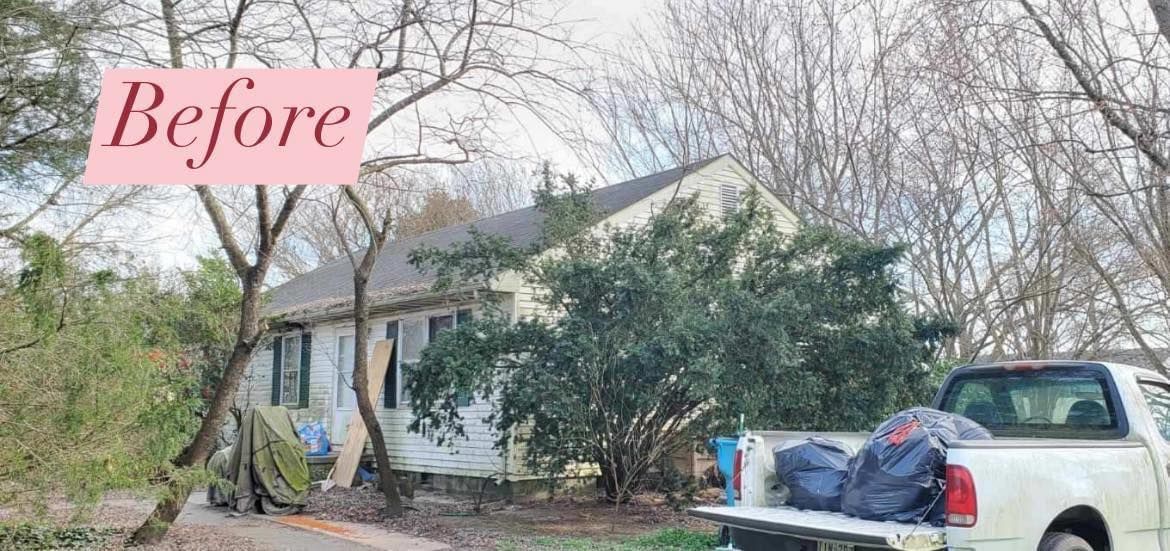 Pre-renovation house with trees and truck